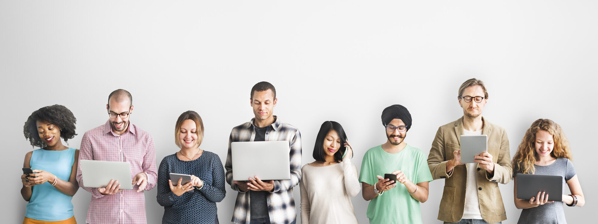 A line of people holding different types of devices.
